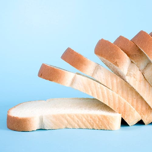 Slices of white bread on a blue background